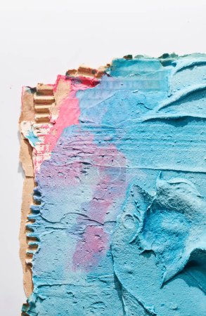 Photo for Blue ragged pieces of cardboard abstract background, chaotic paint dashes and strokes over plaster applied with spatula, putty textur - Royalty Free Image