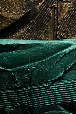 Photo for Decorative black gold green putty background. Wall texture with filler paste applied with spatula, chaotic dashes and strokes over plaster. Creative design, stone pattern, cemen - Royalty Free Image