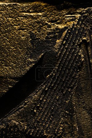 Photo for Decorative black gold putty background. Wall texture with filler paste applied with spatula, chaotic dashes and strokes over plaster. Creative design, stone pattern, cemen - Royalty Free Image