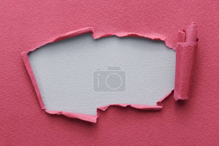 Photo for Frame of ripped paper with torn edges. Window for text with copy space red burgundy grey colors, shreds of notebook pages. Abstract backgroun - Royalty Free Image