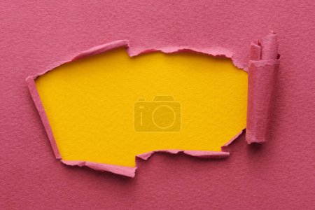 Photo for Frame of ripped paper with torn edges. Window for text with copy space yellow burgundy red colors, shreds of notebook pages. Abstract backgroun - Royalty Free Image
