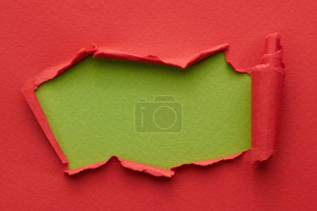 Photo for Frame of ripped paper with torn edges. Window for text with copy space red green colors, shreds of notebook pages. Abstract backgroun - Royalty Free Image