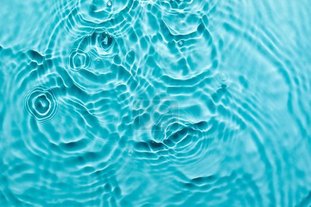 Foto de Fondo abstracto de superficie azul agua. Ondas y ondas textura de la crema hidratante cosmética aqua con burbujas - Imagen libre de derechos