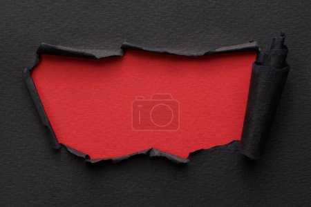 Photo for Frame of ripped paper with torn edges. Window for text with copy space red black colors, shreds of notebook pages. Abstract backgroun - Royalty Free Image