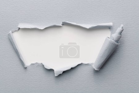 Photo for Frame of ripped paper with torn edges. Window for text with copy space gray white colors, shreds of notebook pages. Abstract backgroun - Royalty Free Image