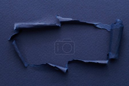 Photo for Frame of ripped paper with torn edges. Window for text with copy space blue colors, shreds of notebook pages. Abstract backgroun - Royalty Free Image