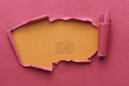 Photo for Frame of ripped paper with torn edges. Window for text with copy space red burgundy brown colors, shreds of notebook pages. Abstract backgroun - Royalty Free Image