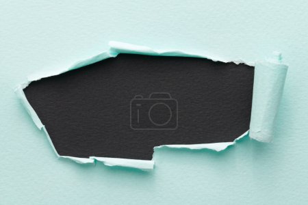 Photo for Frame of ripped paper with torn edges. Window for text with copy space black blue colors, shreds of notebook pages. Abstract backgroun - Royalty Free Image