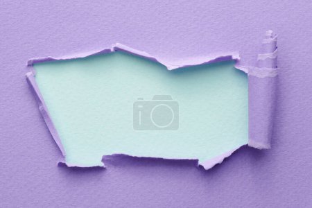 Photo for Frame of ripped paper with torn edges. Window for text with copy space blue lilac colors, shreds of notebook pages. Abstract backgroun - Royalty Free Image