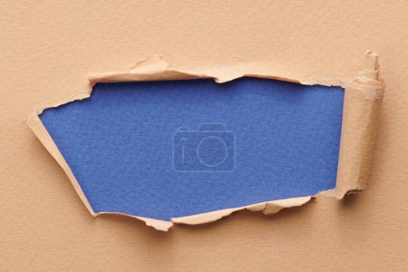 Photo for Frame of ripped paper with torn edges. Window for text with copy space blue beige colors, shreds of notebook pages. Abstract backgroun - Royalty Free Image