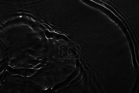 Photo for Water black surface abstract background. Waves and ripples texture of cosmetic aqua moisturizer with bubble - Royalty Free Image