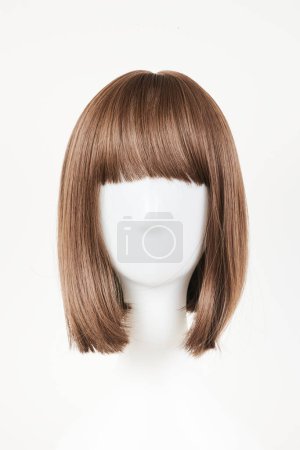 Photo for Natural looking dark brunet wig on white mannequin head. Middle length brown hair on the plastic wig holder isolated on white background, front view - Royalty Free Image