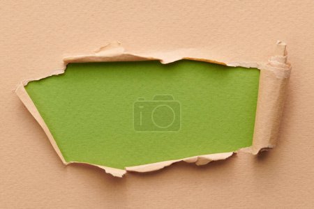 Photo for Frame of ripped paper with torn edges. Window for text with copy space green beige colors, shreds of notebook pages. Abstract backgroun - Royalty Free Image