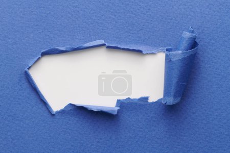 Photo for Frame of ripped paper with torn edges. Window for text with copy space blue white colors, shreds of notebook pages. Abstract backgroun - Royalty Free Image