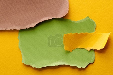 Photo for Art collage of pieces of ripped paper with torn edges. Sticky notes collection yellow brown green colors, shreds of notebook pages. Abstract backgroun - Royalty Free Image