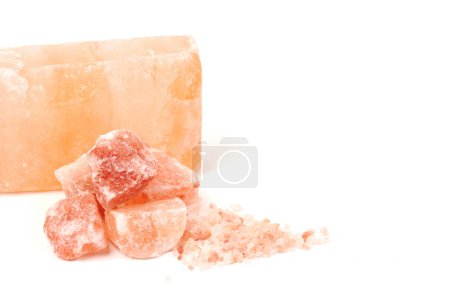 Photo for Chipped Himalayan salt stone, crystals and crushed blocks of natural pink salt isolated on white background - Royalty Free Image