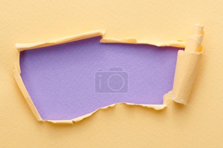 Photo for Frame of ripped paper with torn edges. Window for text with copy space lilac beige colors, shreds of notebook pages. Abstract backgroun - Royalty Free Image