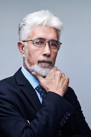 Photo for Portrait of confident mature businessman with serious face and gray hair isolated on studio background. Good looking 60 year old man, boss in sui - Royalty Free Image