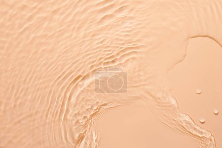 Photo for Water beige surface abstract background. Waves and ripples texture of cosmetic aqua moisturizer with bubble - Royalty Free Image