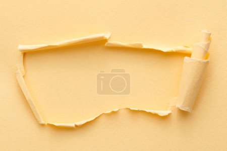 Photo for Frame of ripped paper with torn edges. Window for text with copy space beige colors, shreds of notebook pages. Abstract backgroun - Royalty Free Image