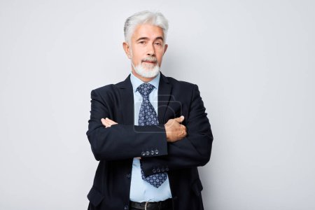 Téléchargez les photos : Portrait d'homme d'affaires mature confiant au visage sérieux et aux cheveux gris isolés sur fond de studio. Beau 60 ans, patron à Sui - en image libre de droit