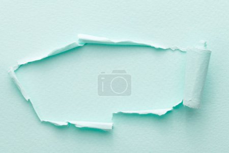 Photo for Frame of ripped paper with torn edges. Window for text with copy space blue colors, shreds of notebook pages. Abstract backgroun - Royalty Free Image