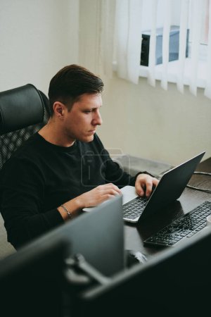 Photo for Portrait professional man programmer working concentrated on computer in diverse offices. Modern IT technologies, development of artificial intelligence, programs, applications and video games concep - Royalty Free Image