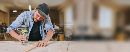 Photo for Carpenter works with wood in carpentry workshop. Man doing woodwork professionally - Royalty Free Image