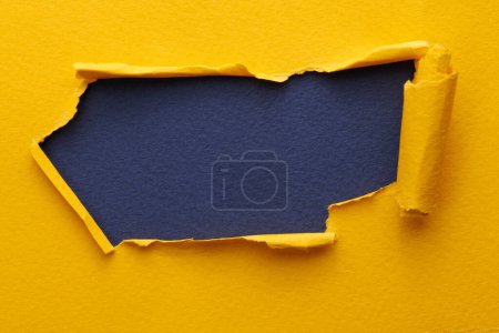 Photo for Frame of ripped paper with torn edges. Window for text with copy space yellow blue colors, shreds of notebook pages. Abstract backgroun - Royalty Free Image
