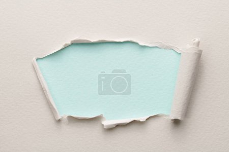 Photo for Frame of ripped paper with torn edges. Window for text with copy space blue white colors, shreds of notebook pages. Abstract backgroun - Royalty Free Image