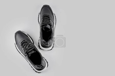 Foto de Par de zapatillas de deporte de cuero negro aisladas sobre fondo blanco con espacio para copiar, vista superior - Imagen libre de derechos