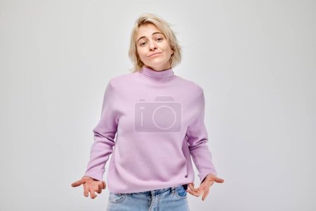 Photo for Portrait of student girl showing empty pockets isolated on white studio background. Financial crisis, no money concept - Royalty Free Image