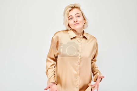 Photo for Portrait of student girl showing empty pockets isolated on white studio background. Financial crisis, no money concept - Royalty Free Image