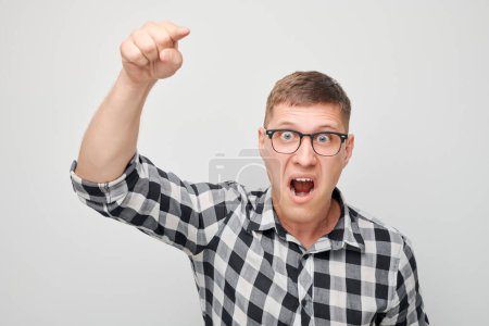 Photo for Portrait of angry young man yelling pointing menacingly at camera isolated on white studio background. Devil boss face. Human emotions, facial expression concept - Royalty Free Image