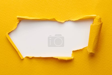 Photo for Frame of ripped paper with torn edges. Window for text with copy space yellow white colors, shreds of notebook pages. Abstract backgroun - Royalty Free Image