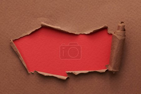 Photo for Frame of ripped paper with torn edges. Window for text with copy space red brown colors, shreds of notebook pages. Abstract backgroun - Royalty Free Image