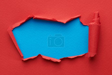 Photo for Frame of ripped paper with torn edges. Window for text with copy space red blue colors, shreds of notebook pages. Abstract backgroun - Royalty Free Image