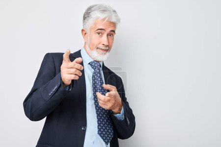 Photo for Portrait of confident businessman in suit chooses you points finger at camera isolated on white studio background. Welcome gesture, join our team concep - Royalty Free Image