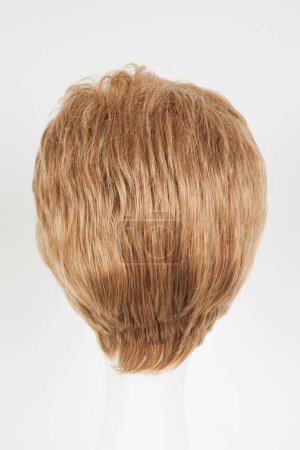 Photo for Natural looking blonde fair wig on white mannequin head. Short hair cut on the plastic wig holder isolated on white background, back vie - Royalty Free Image