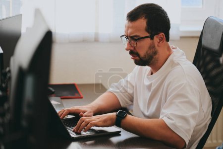 Photo for Portrait professional man programmer working concentrated on computer in diverse offices. Modern IT technologies, development of artificial intelligence, programs, applications and video games concep - Royalty Free Image