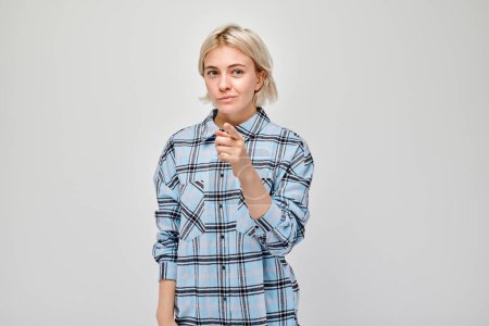 Photo for Portrait of confident girl chooses you points finger at camera isolated on white studio background. Welcome gesture, join our team concep - Royalty Free Image