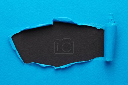 Photo for Frame of ripped paper with torn edges. Window for text with copy space black blue colors, shreds of notebook pages. Abstract backgroun - Royalty Free Image