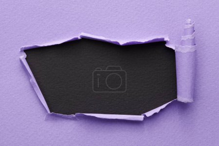 Photo for Frame of ripped paper with torn edges. Window for text with copy space black lilac colors, shreds of notebook pages. Abstract backgroun - Royalty Free Image