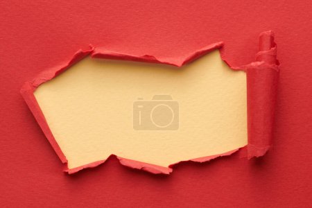 Photo for Frame of ripped paper with torn edges. Window for text with copy space red beige colors, shreds of notebook pages. Abstract backgroun - Royalty Free Image
