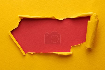 Photo for Frame of ripped paper with torn edges. Window for text with copy space yellow red colors, shreds of notebook pages. Abstract backgroun - Royalty Free Image