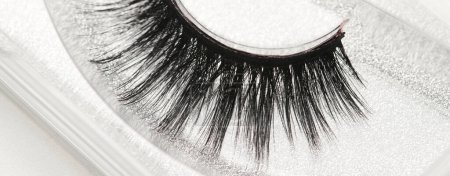 Photo for Black long false eyelashes close-up on white background. Self-adhesive eyelashes, eyelash extensions, mascara effec - Royalty Free Image