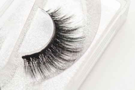 Photo for Black long false eyelashes close-up on white background. Self-adhesive eyelashes, eyelash extensions, mascara effec - Royalty Free Image