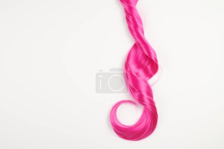 Téléchargez les photos : Naturel cheveux brillants rose couleur vive, perruque cosplay sur un fond blanc - en image libre de droit