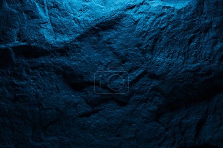 Photo for Black stone texture in blue neon lighting, dark abstract background. Natural mineral rock close up details, empty backdrop with copy space for design - Royalty Free Image