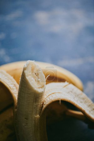 Photo for Close-up of bananas on blue textured background - Royalty Free Image